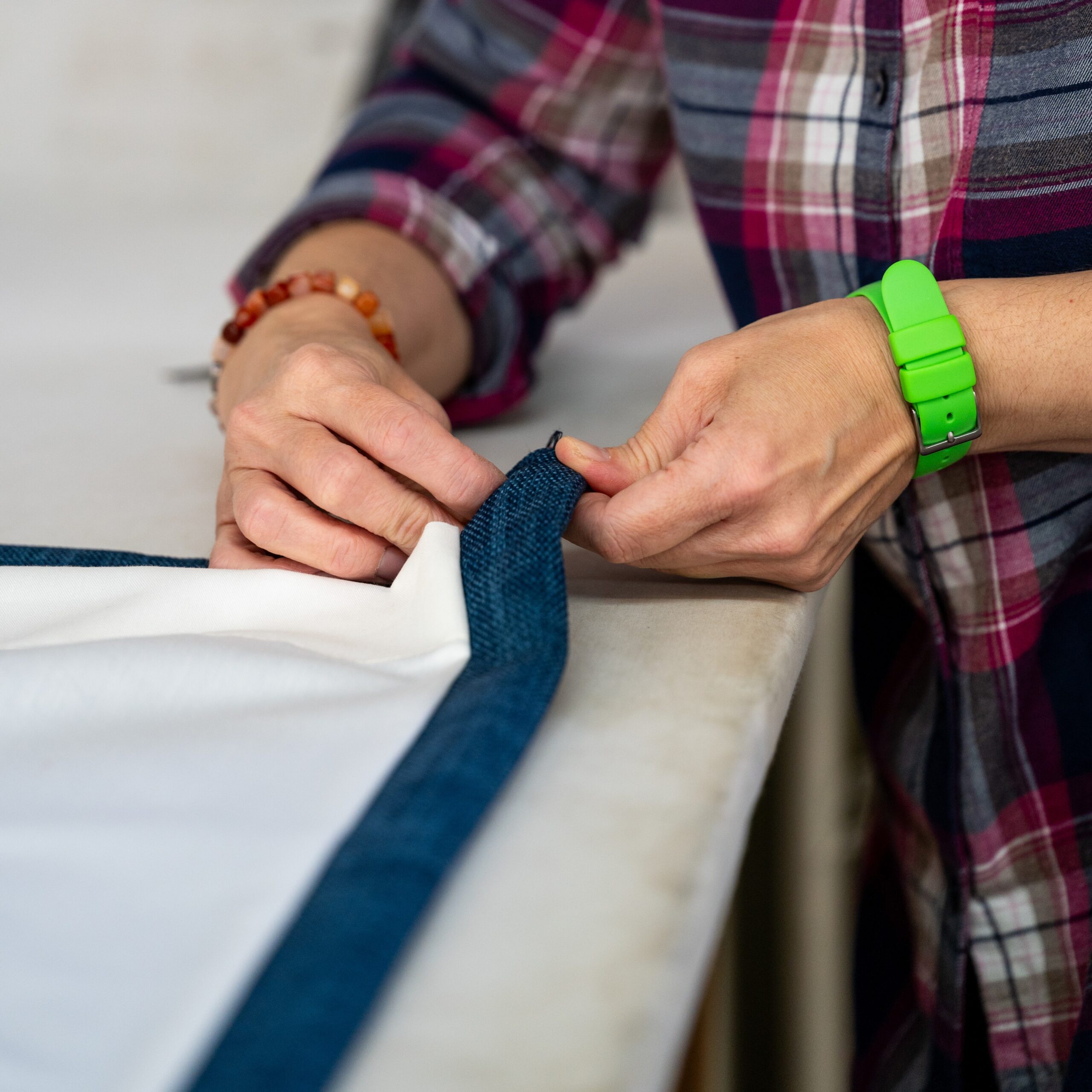 Attaching blue trim to curtain fabric