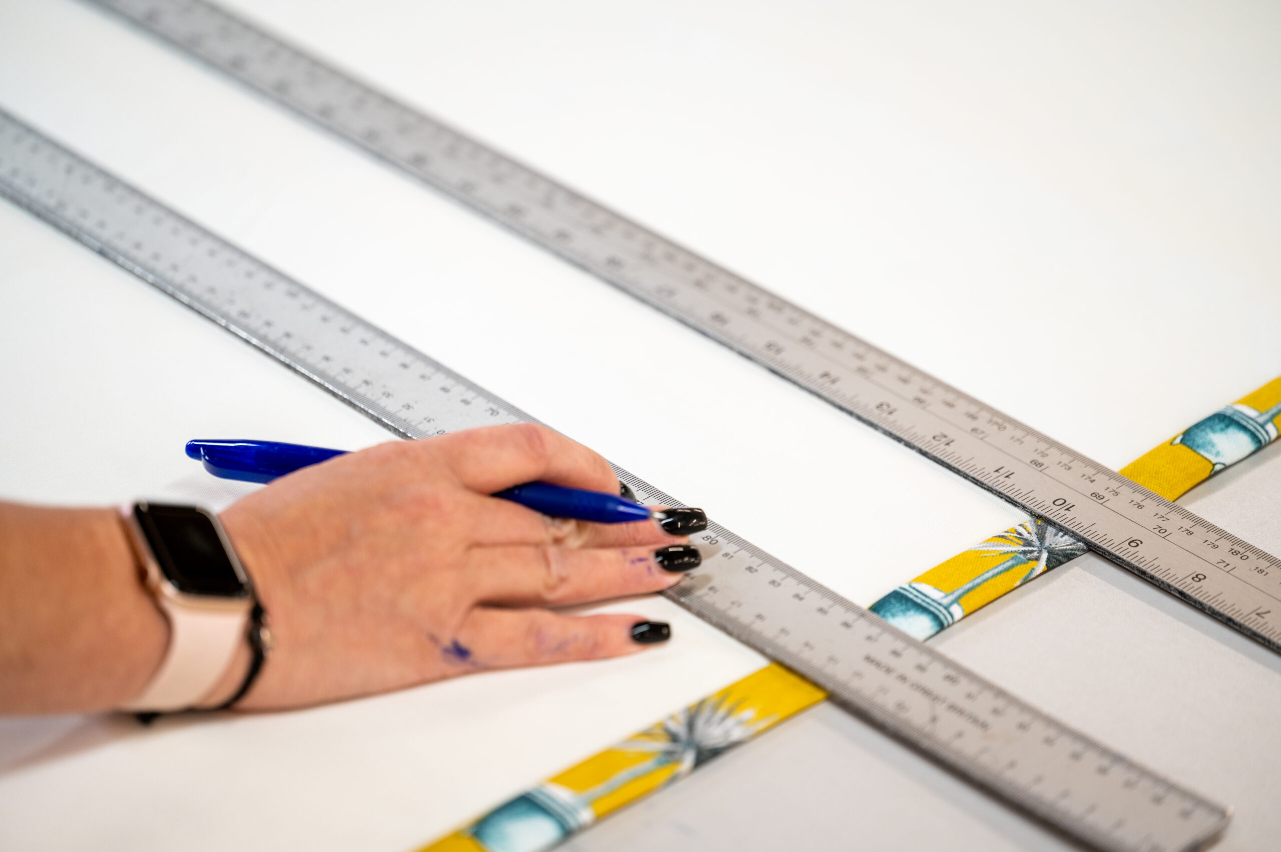 Measuring fabric with metal rulers