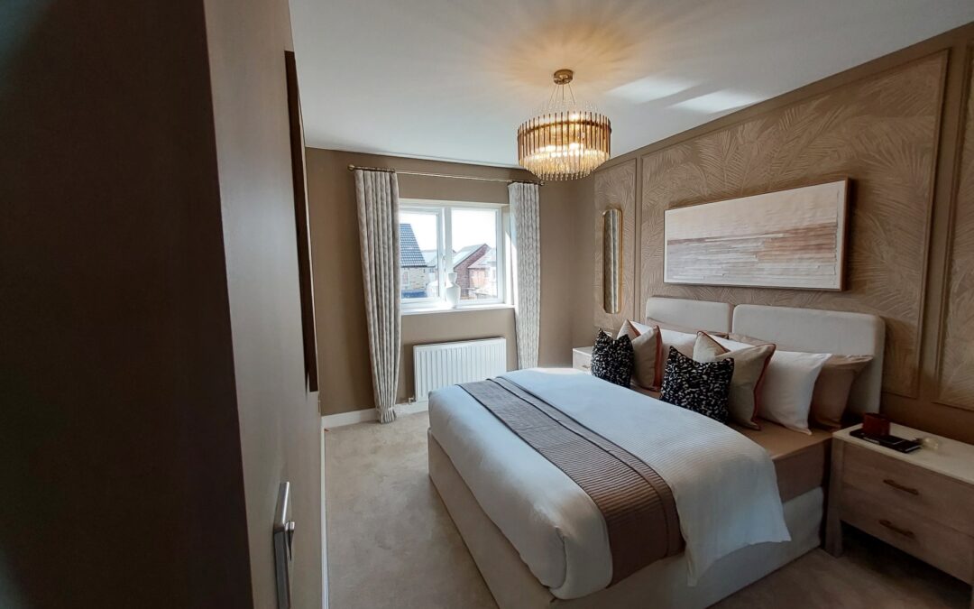 Neutral bedroom with upholstered bed and chandelier