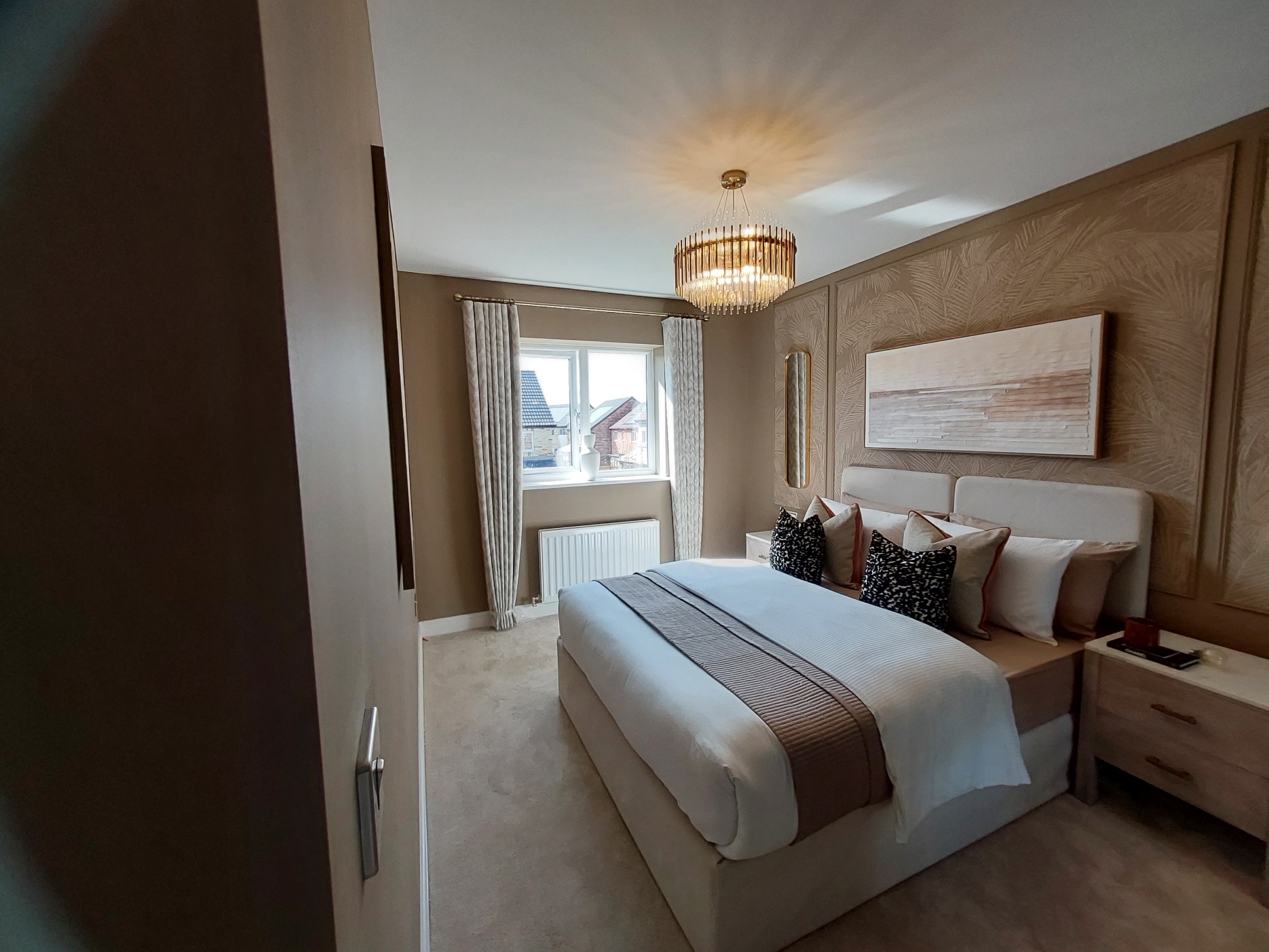 Neutral bedroom with upholstered bed and chandelier