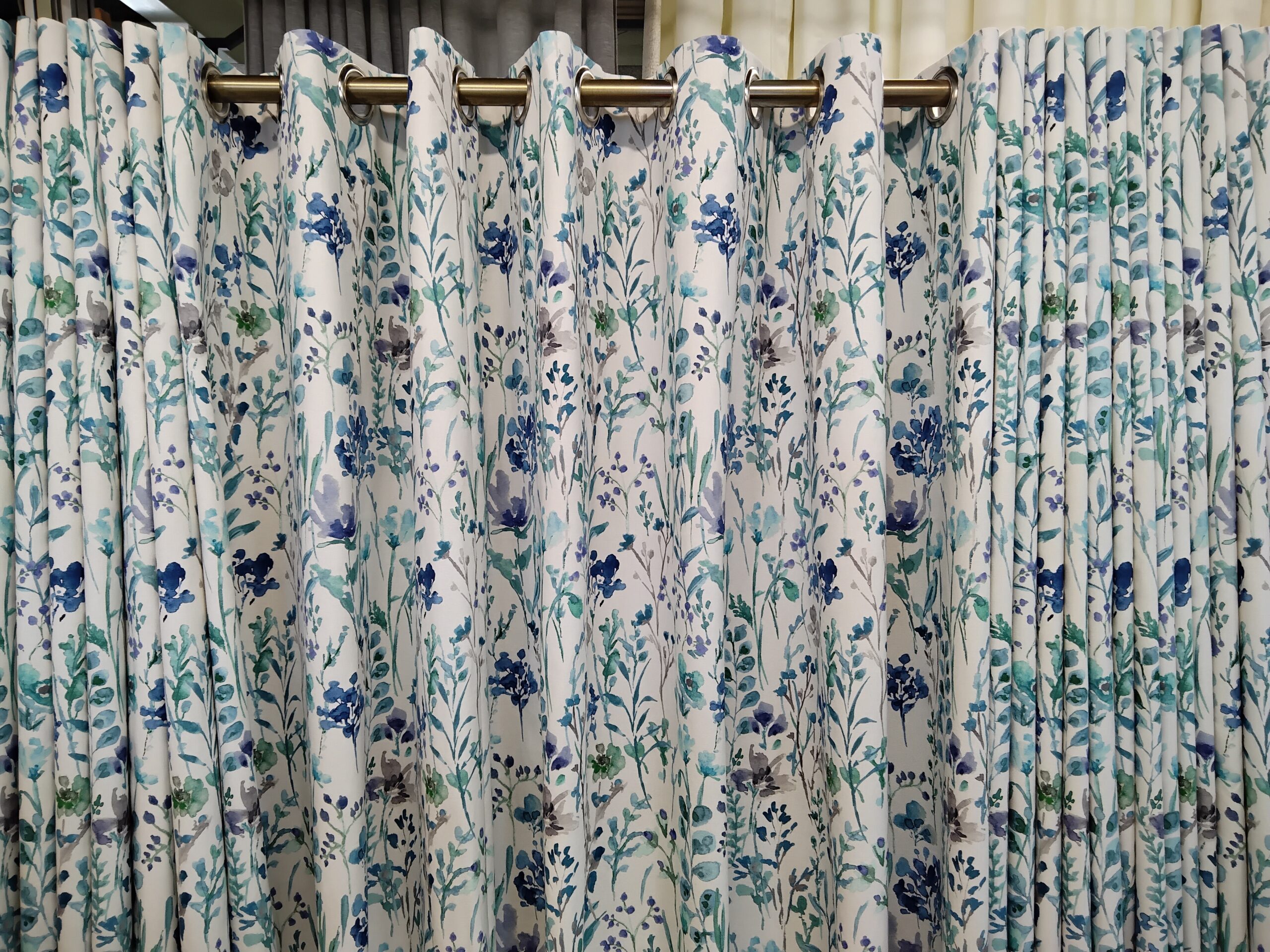 drapes Blue floral eyelet curtains on brass curtain pole